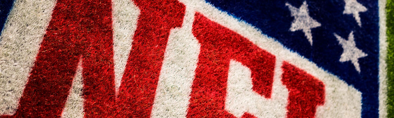 The NFL banner on a field of green.