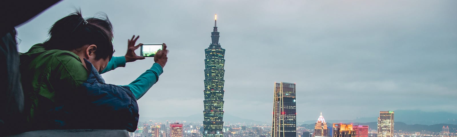 Someone takes a picture of a city at dusk