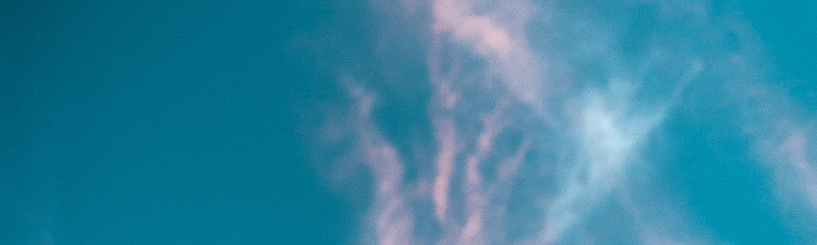 A lower arm and hand reaches up to a blue sky (with a few clouds). Menopausal hot flashes are a problem for many of my patients, including women going through menopause or men receiving some prostate cancer treatments.