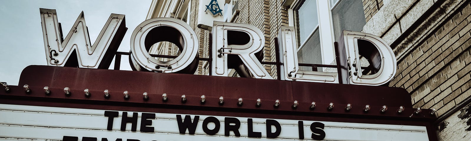 An old cinema listings board that reads “the world is currently closed”