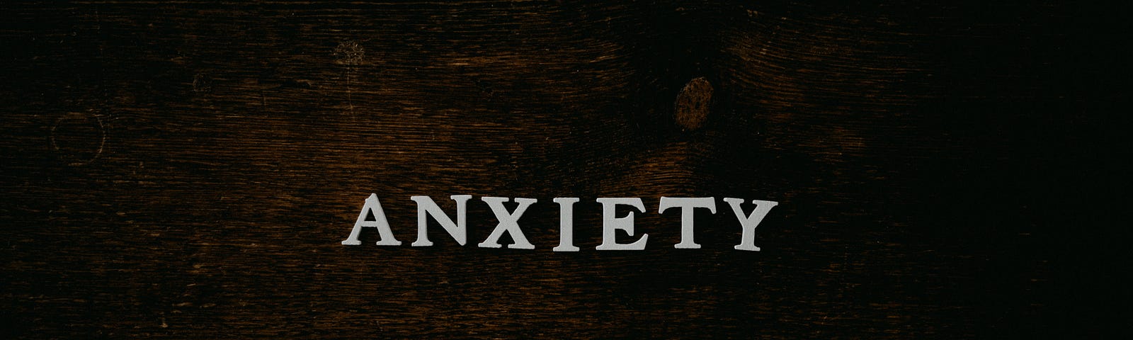 ‘Anxiety’ written in white letters on a wooden surface