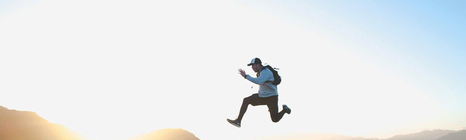 Picture of a man running and jumping happily via Alt text on Medium