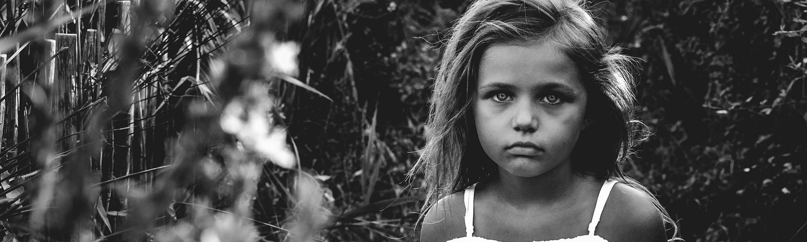 Black & white photo of a sad little girl.