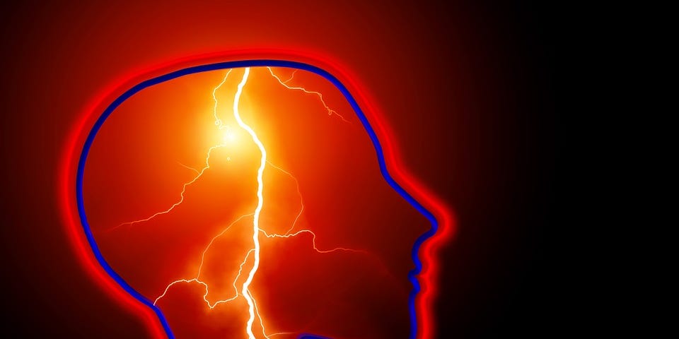 Side view outline of human head and neck in blue and red with a lightning strike running from the top of the head down the neck.