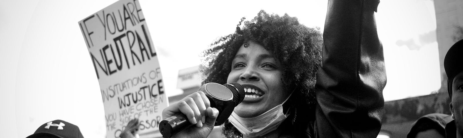 Young woman holding a mic in public. Fatunla Samuel.