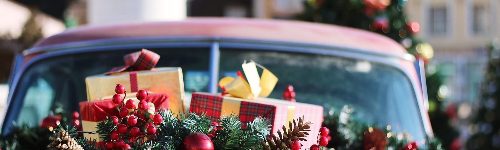 A red car with Christmas presents all over it. Photo by Honey Fangs on Unsplash