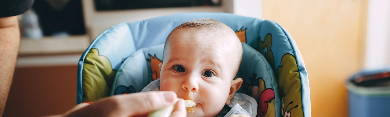 little baby eating yummy food from spoon