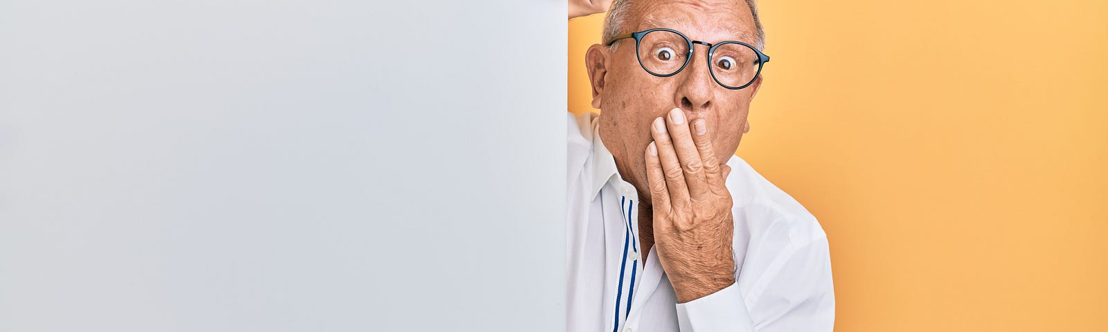 Surprised grandpa on gray and yellow background