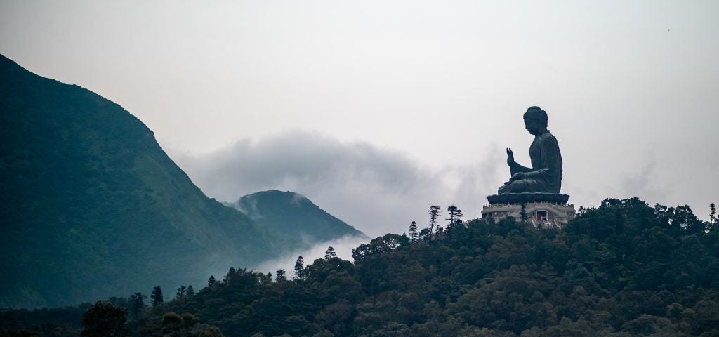 Buddha statue on foggy mountain