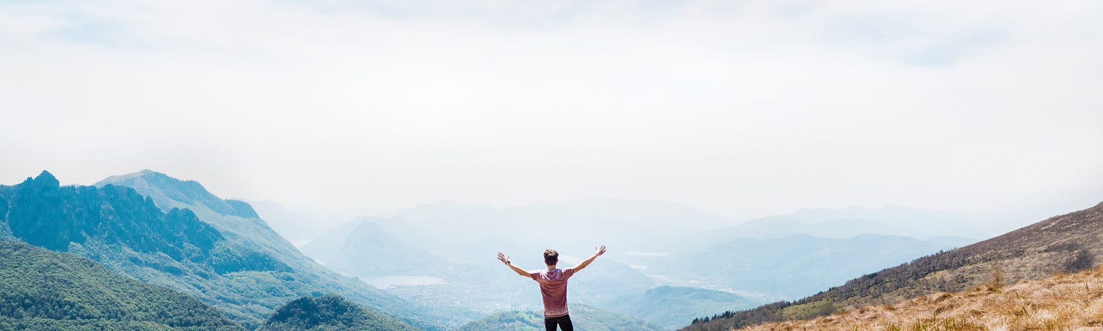 A person celebrating on a mountain top.