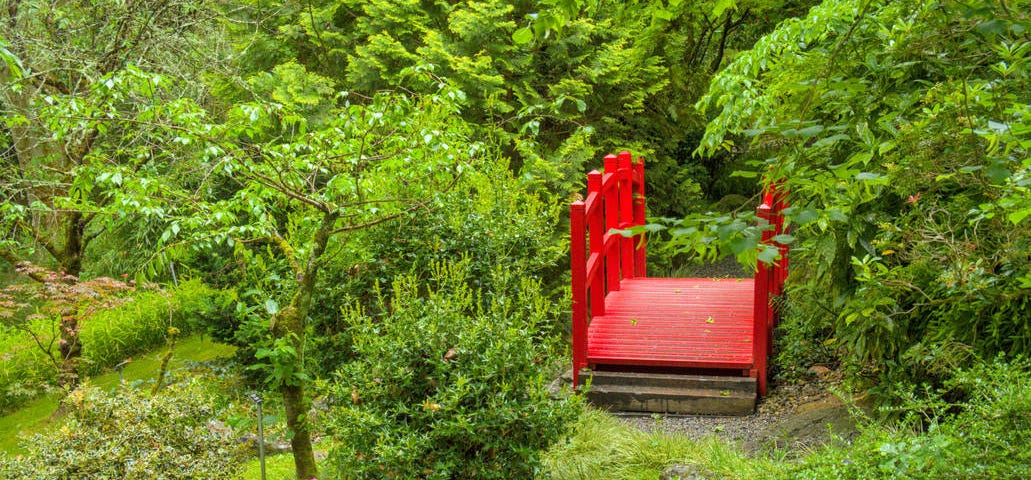 A red bridge in a japanese-style garden