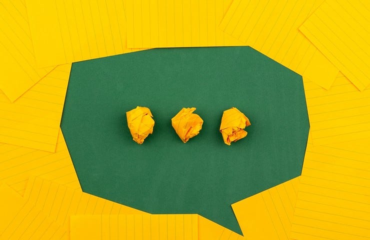 Image from Volodymyr Hryshchenko of green conversation bubble against a yellow background.