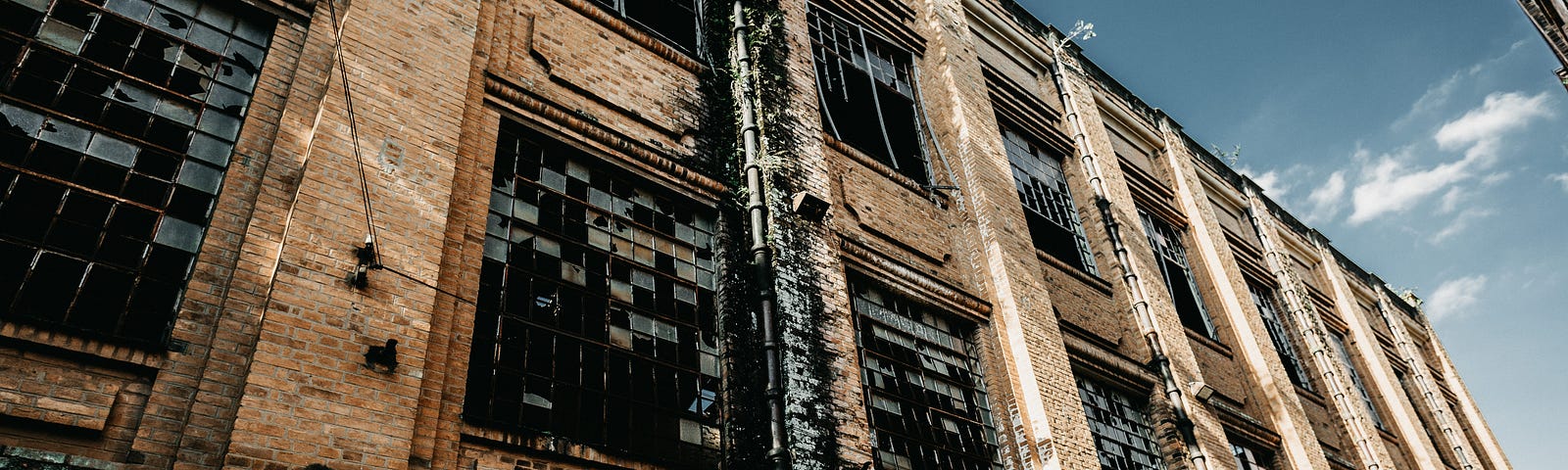 A large old, seemingly deserted factory building.