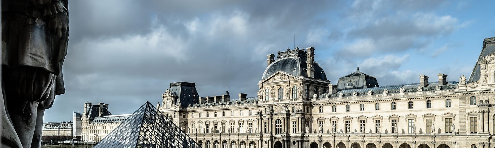 The Louvre in Paris with a few people