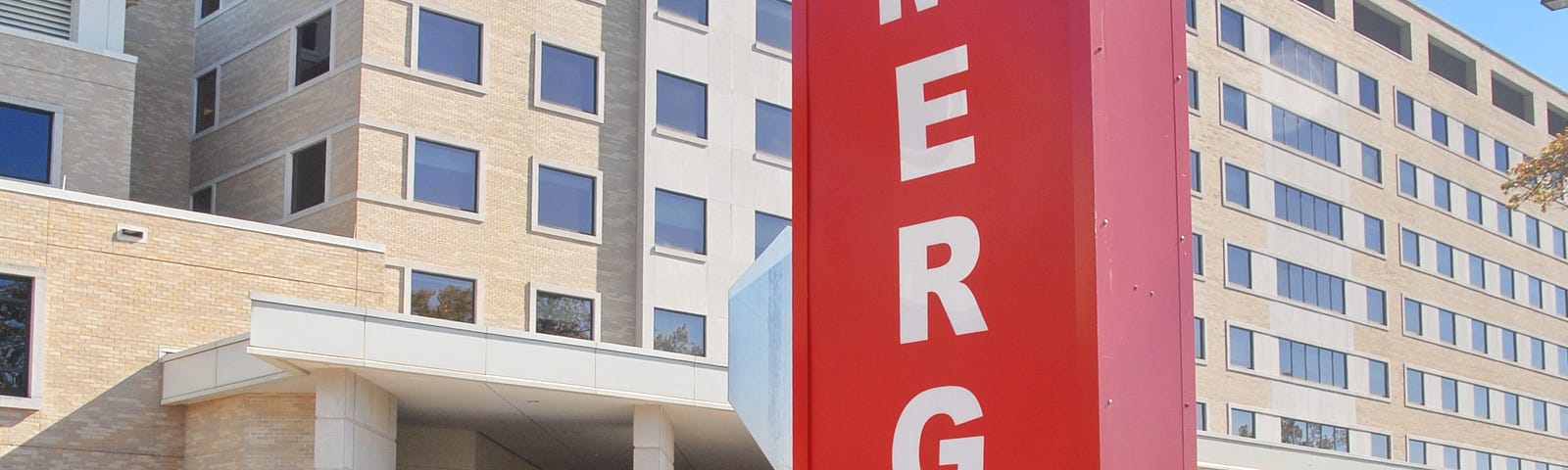 A hospital building with Emergency Sign in red.