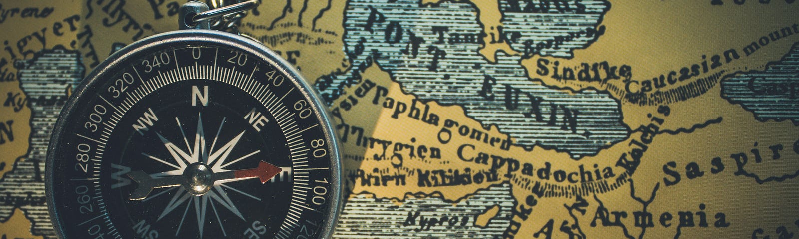 A map with a compass pointing east on top of it
