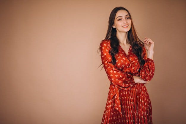 Beautiful young woman in a burnt orange colored dress