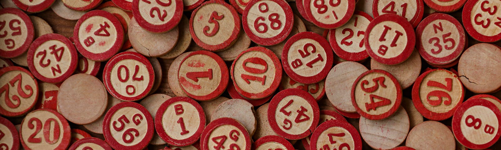 wooden bingo markers with red rims and numbers
