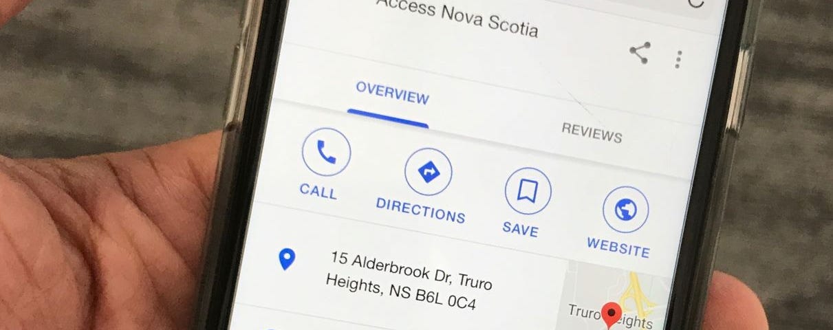 A cell phone showing Google location information for an Access Nova Scotia service location.