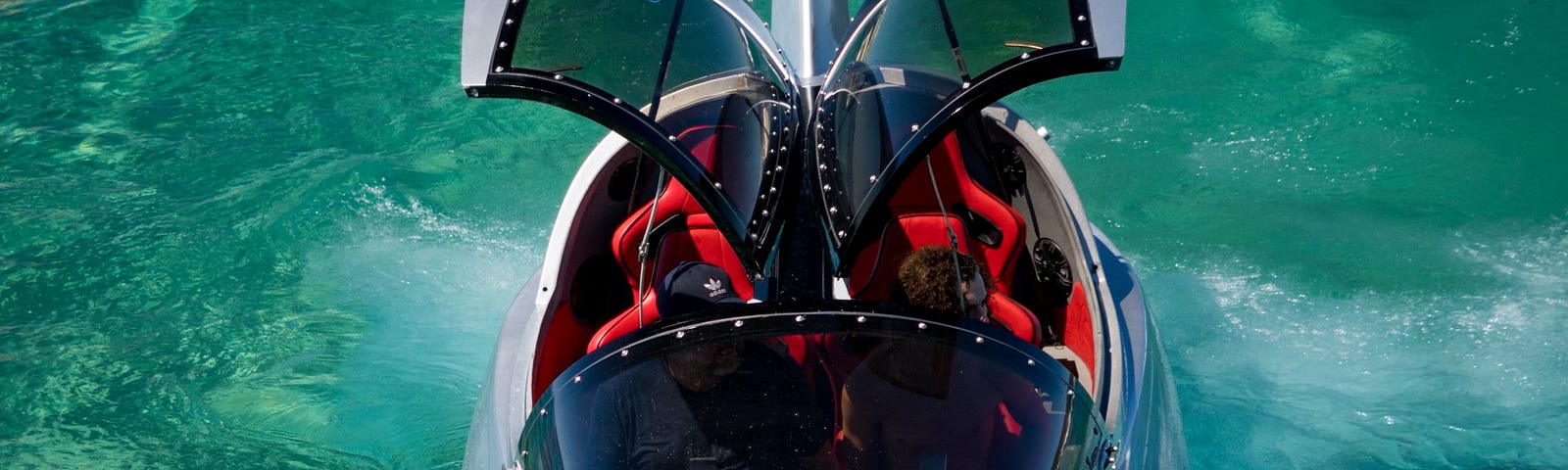 Looking down at the Jet Shark’s bow with gull wing doors open and floating on water.