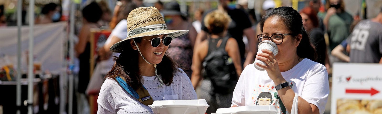 People make their way down the aisle at the Farmers Market in Irvine Regional Park on in Irvine, California, on June 15, 2021.