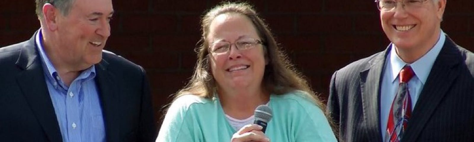 Bigot Kim Davis holding a microphone.