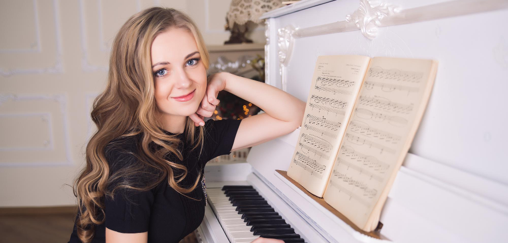 young woman sitting at a piano