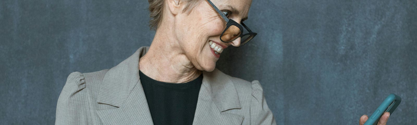 Woman in Gray Blazer Holding Black Tumbler