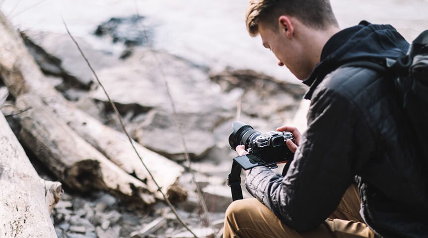 Young man recording video with a FUJIFILM camera
