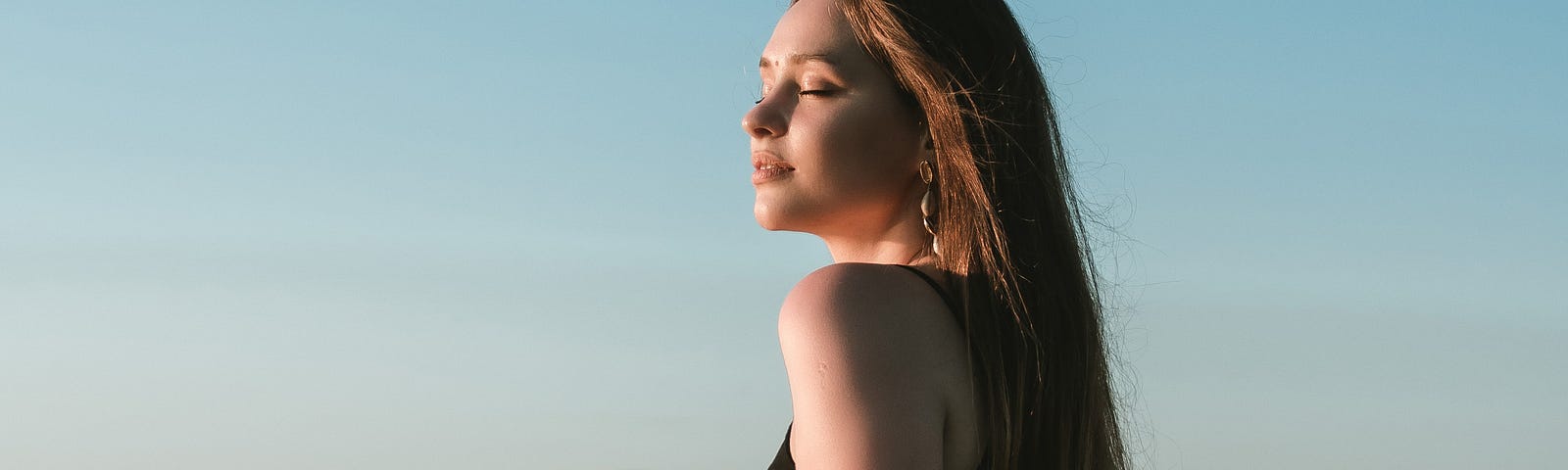 Woman enjoying the ocean breeze