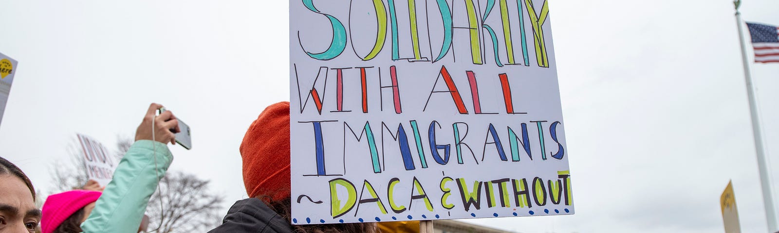 Picture of the Home is Here Walkout with a sign that reads: In solidarity with all Immigrants DACA and without