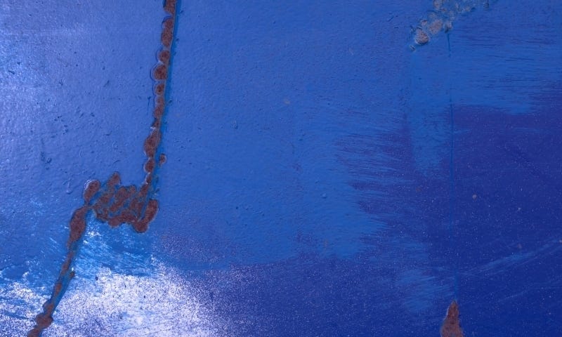 Abstract photograph of blue paint and rust, for healing