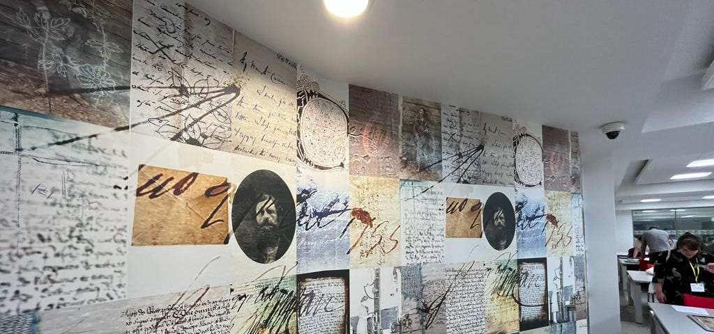 A view inside the Public Record Office of Northern Ireland showing floor to ceiling graphics covering a wall. Photograph taken by Natalie Adams.