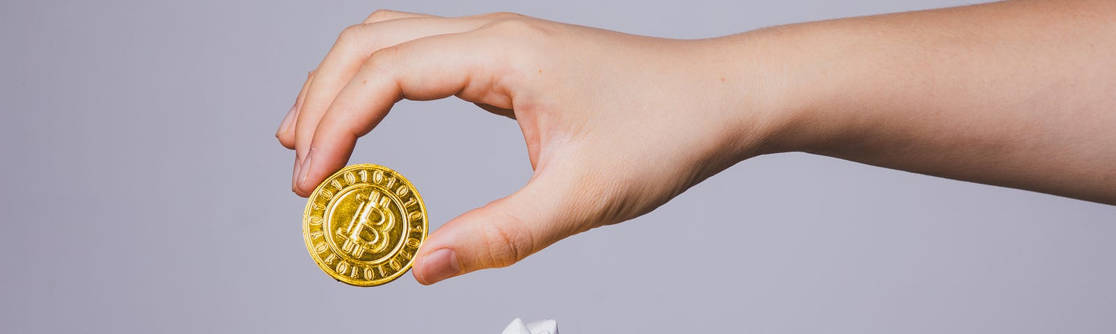 A graphic featuring a person giving a robot bitcoin.