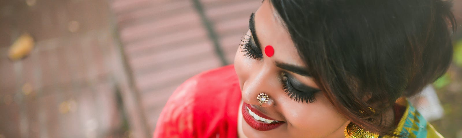 woman in yellow sari smiling