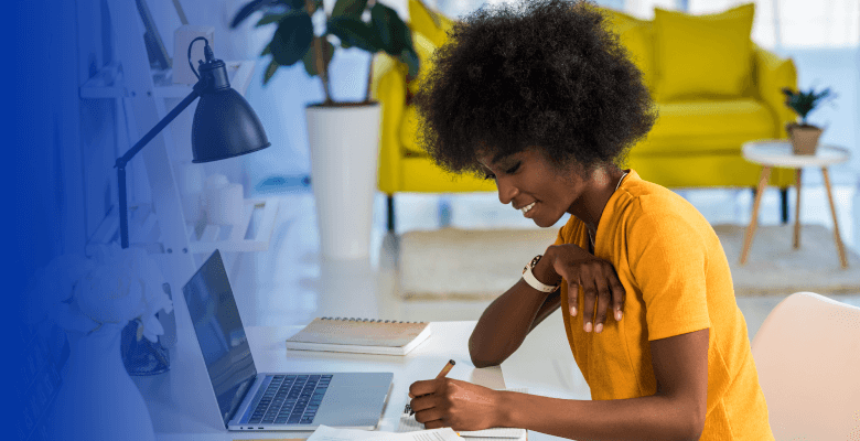 Graphic designer smiling at her desk.