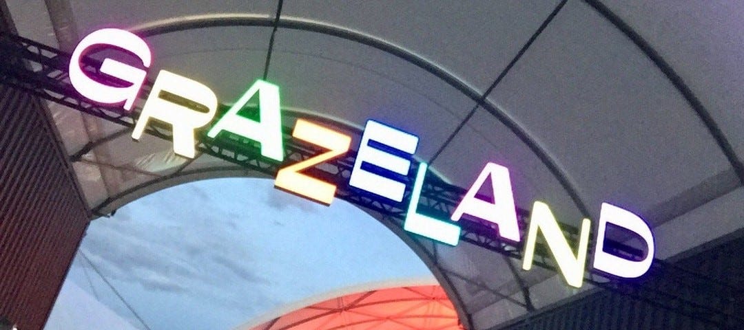 A neon sign with offset, multi-coloured lettering proclaims the entrance to Grazeland.