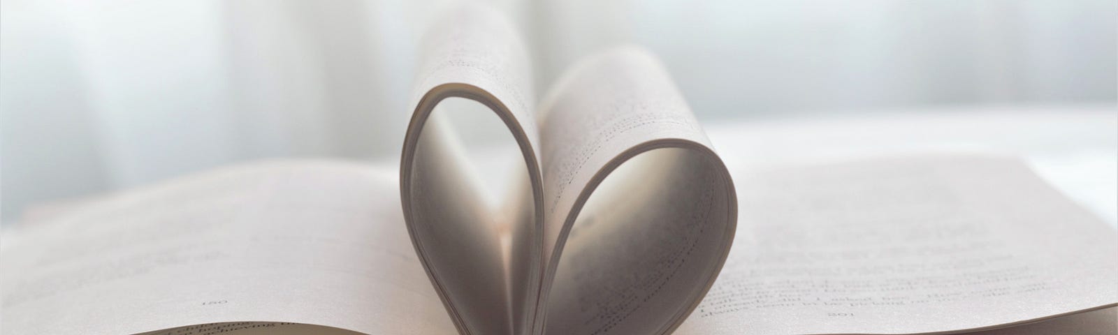 Pages in an open book shaped like a heart