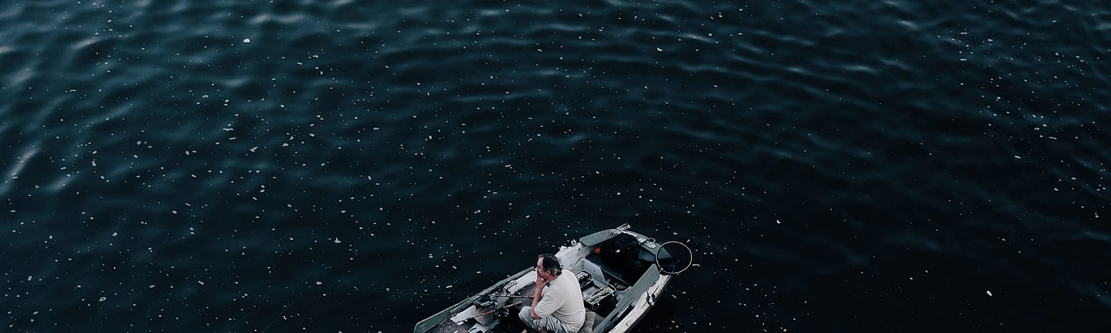 man in gray canoe boat