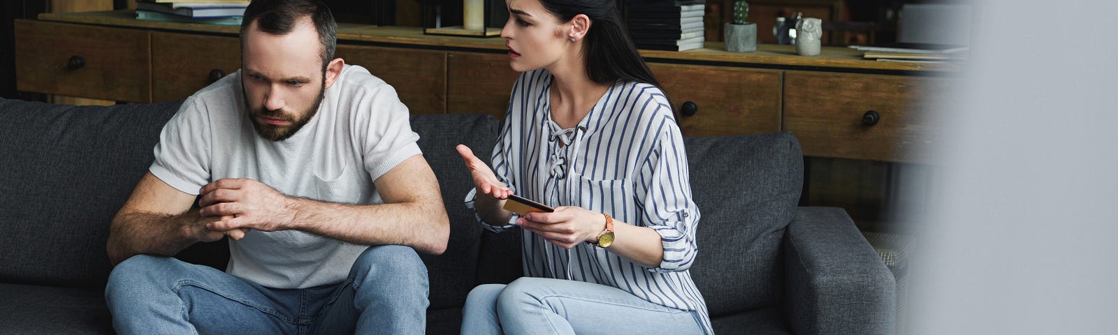 A young couple argue over a credit card.