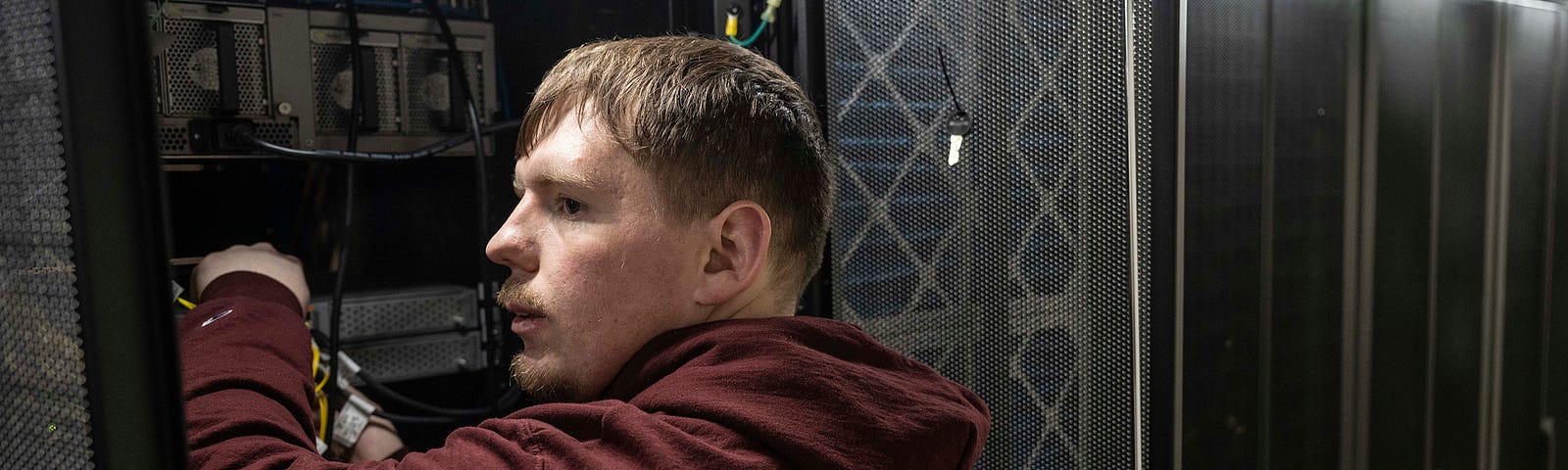 Jace Reddick works on a bank of servers.