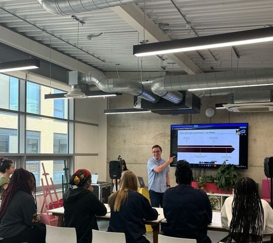 A developer presenting to a group of young women