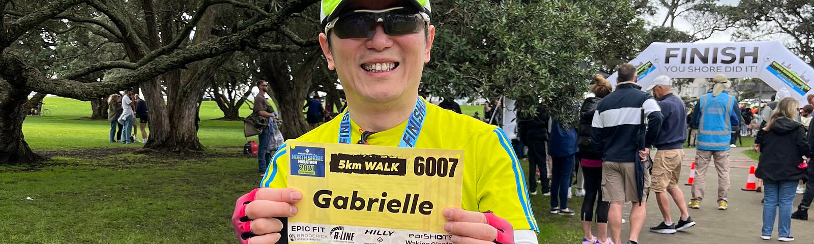 I held my late wife’s race number after completing a half marathon.