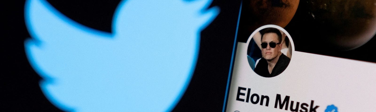 Elon Musk’s twitter account on a smartphone in front of the Twitter logo, April 15, 2022. Photo by Dado Ruvic/Reuters