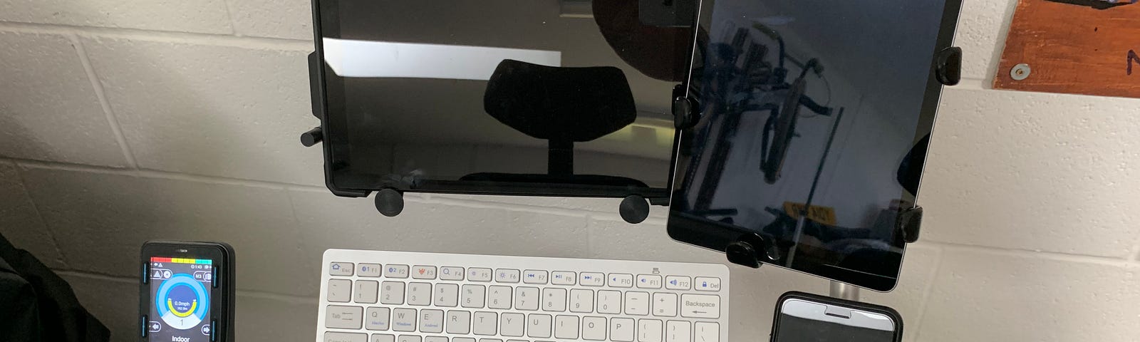 A Surface Pro, iPad and iPhone all mounted side-by-side on a powered wheelchair.