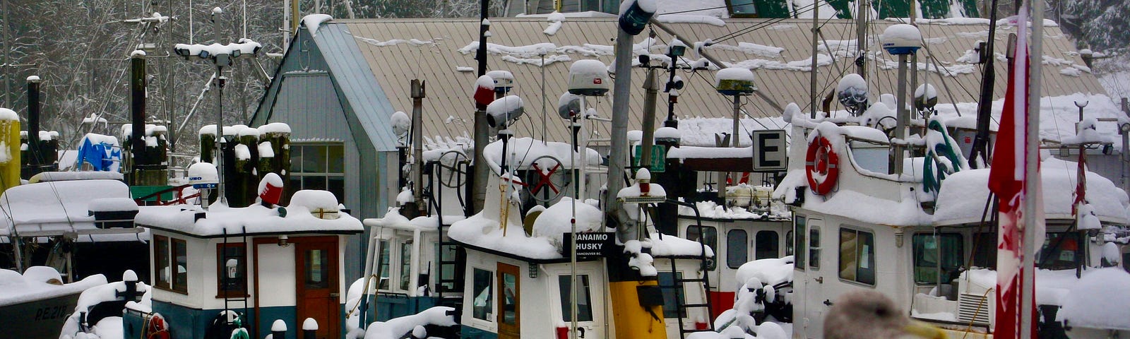 Tug boats at dock with snow creating a winter wonderland