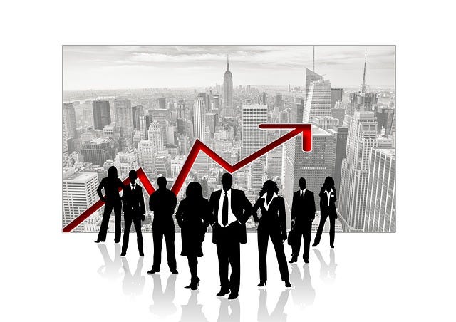 Group of business people in high rise window with big city background and behind them is a jagged red progress arrow on the incline.