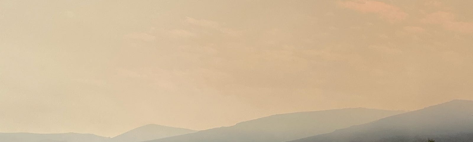 A smoky morning with layers of fading mountains.