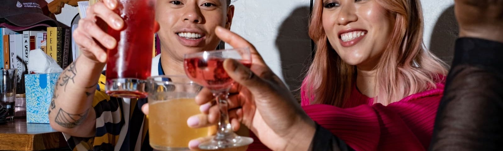 A group of friends of various genders making a toast.