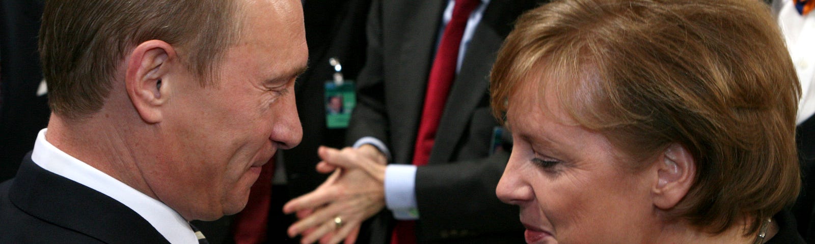 Photograph of Vladimir Putin and Angela Merkel shaking hands in 2007.